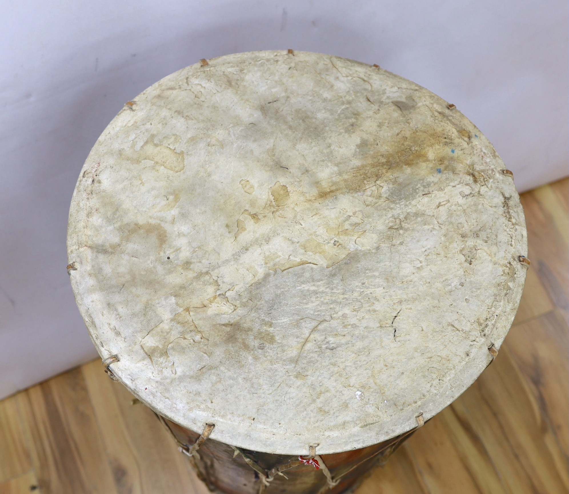 A large sub Saharan tribal drum, 96cm tall